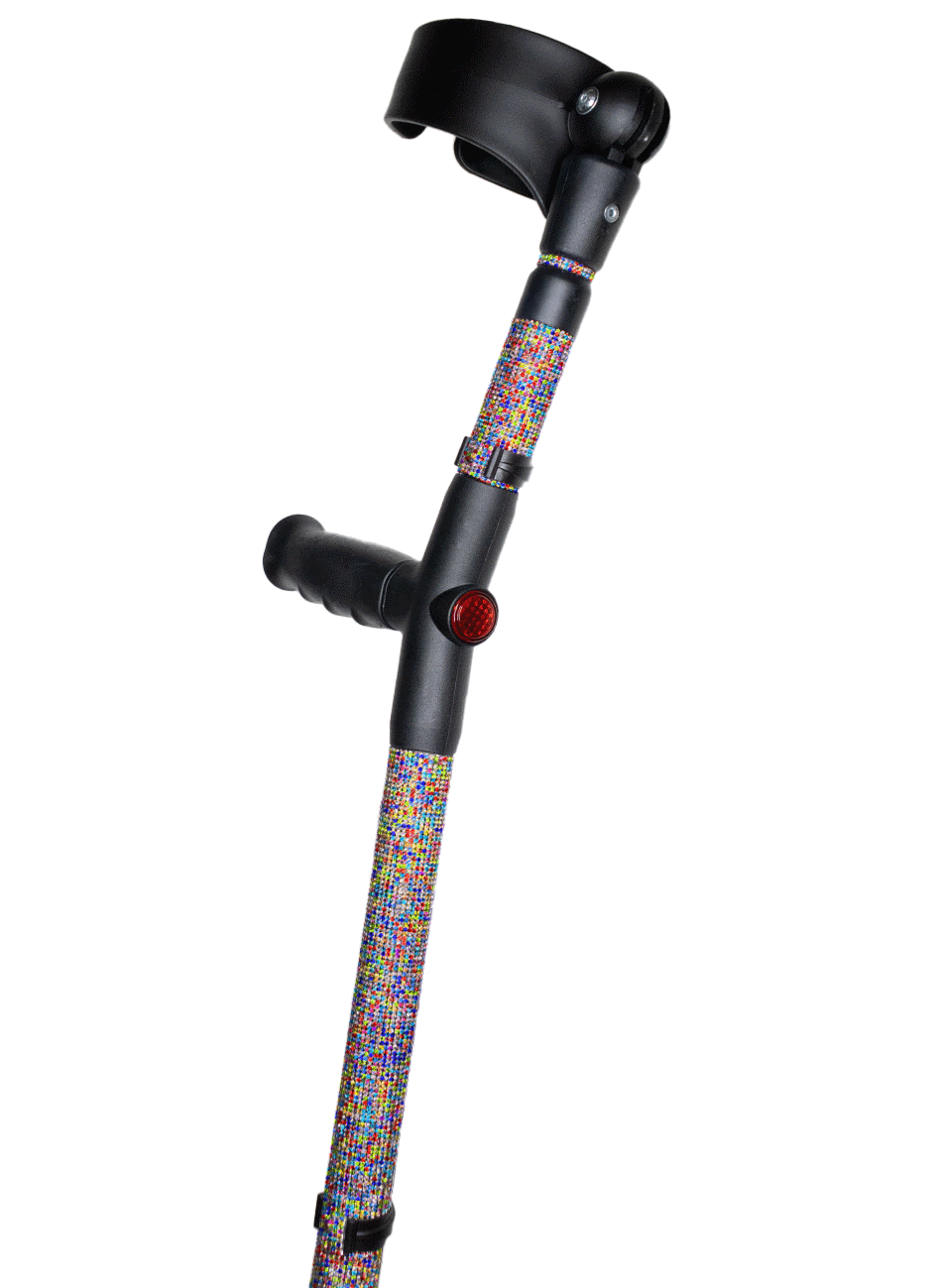 Crutch with a black handle and cuff decorated with multi-colour glass rhinestones. The rhinestones are in a random pattern of different colours including red, green, blue, yellow and pink. The crutch also has a red reflective circle at the back and the front of the handle.