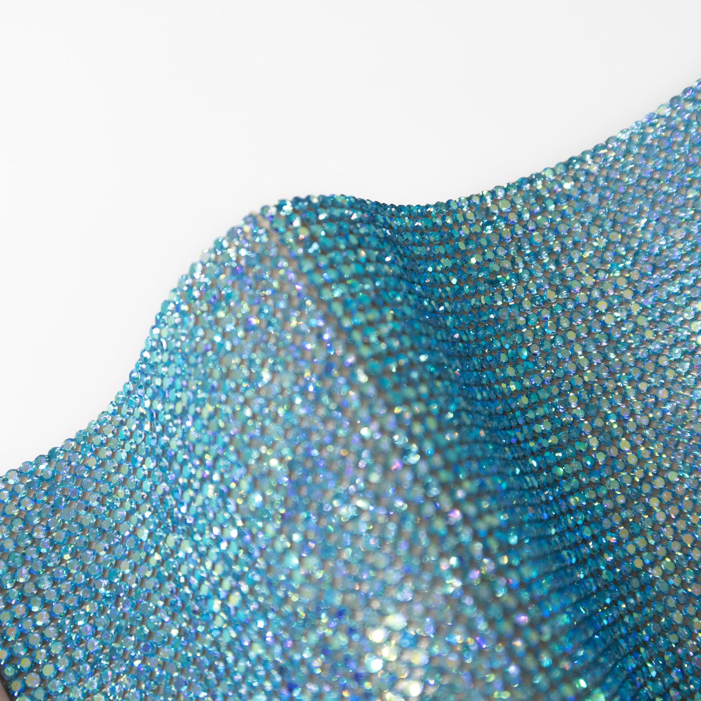 Close up of blue coloured rhinestones with a shimmer effect