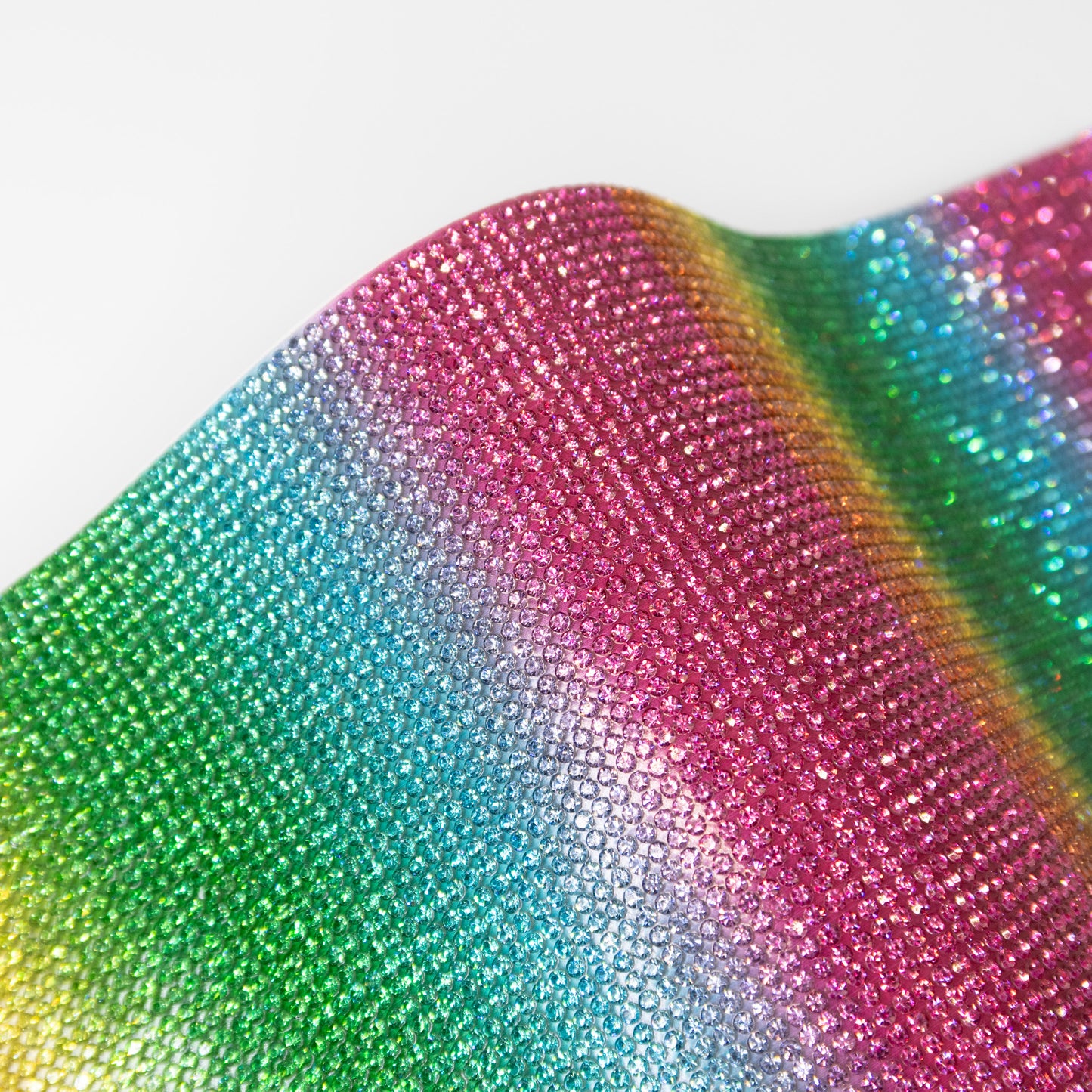 Close up of coloured rhinestones in an striped rainbow pattern