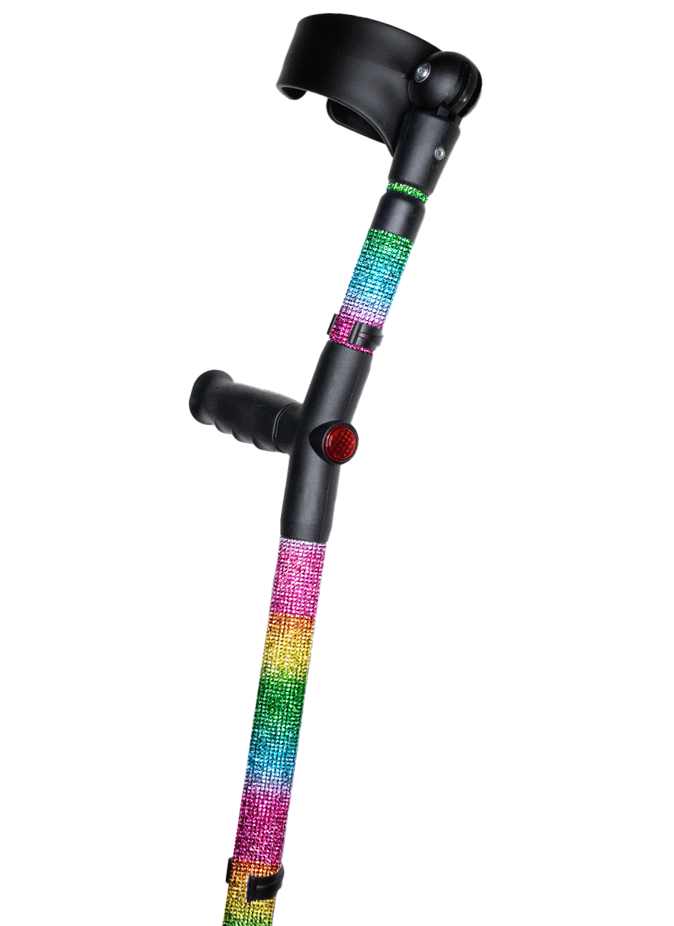 Crutch with a black handle and cuff decorated with coloured glass rhinestones in a striped rainbow pattern. The crutch also has a red reflective circle at the back and the front of the handle.
