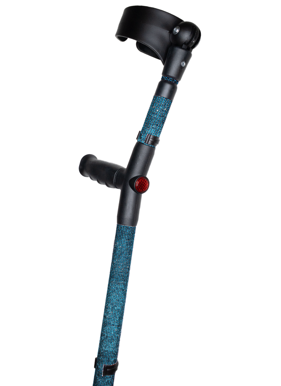 Crutch with a black handle and cuff decorated with teal blue coloured glass rhinestones. The crutch also has a red reflective circle at the back and the front of the handle.
