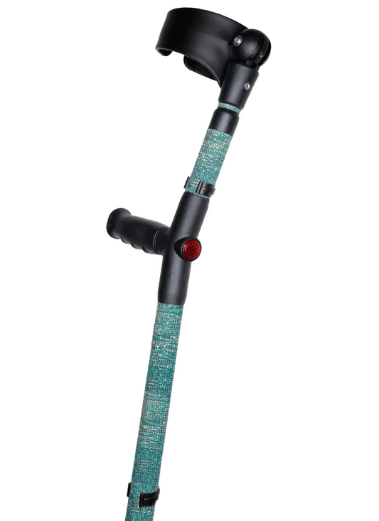 Crutch with a black handle and cuff decorated with blue coloured glass rhinestones.  The crutch also has a red reflective circle at the back and the front of the handle.