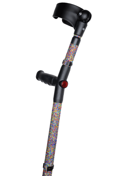 Crutch with a black handle and cuff decorated with multi-colour glass rhinestones.  The rhinestones are in a random pattern of different colours including red, green, blue, yellow and pink. The crutch also has a red reflective circle at the back and the front of the handle.