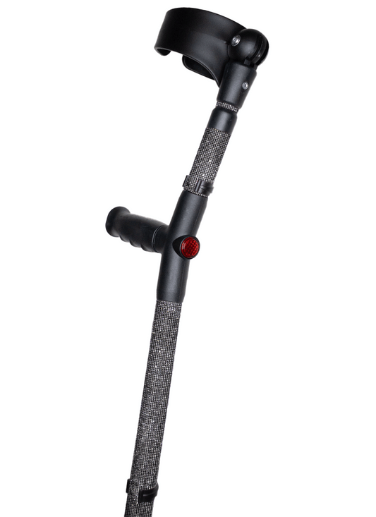 Crutch with a black handle and cuff decorated with graphite (dark grey) coloured glass rhinestones.  The crutch also has a red reflective circle at the back and the front of the handle.