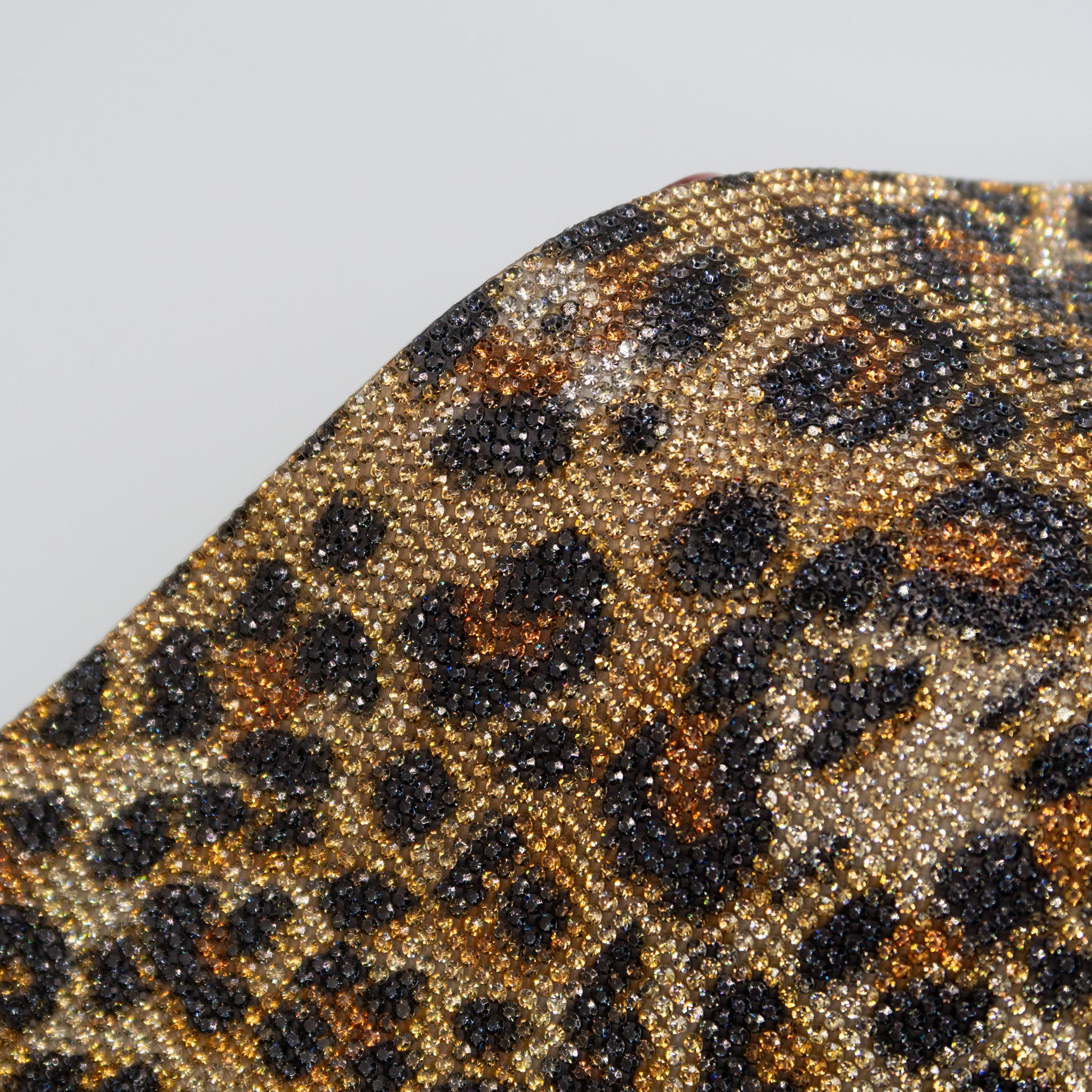 Close up of rhinestones in a black and brown leopard print pattern