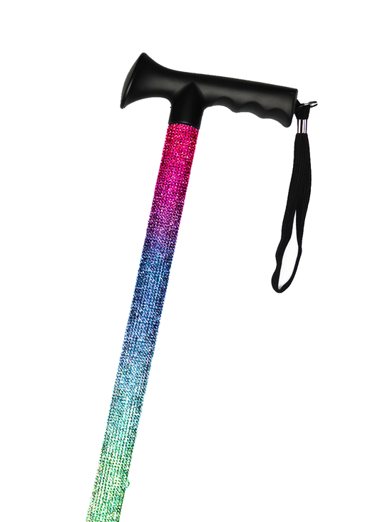 Walking stick with a black handle and black strap decorated with pink, purple and aqua coloured glass rhinestones in an ombré pattern