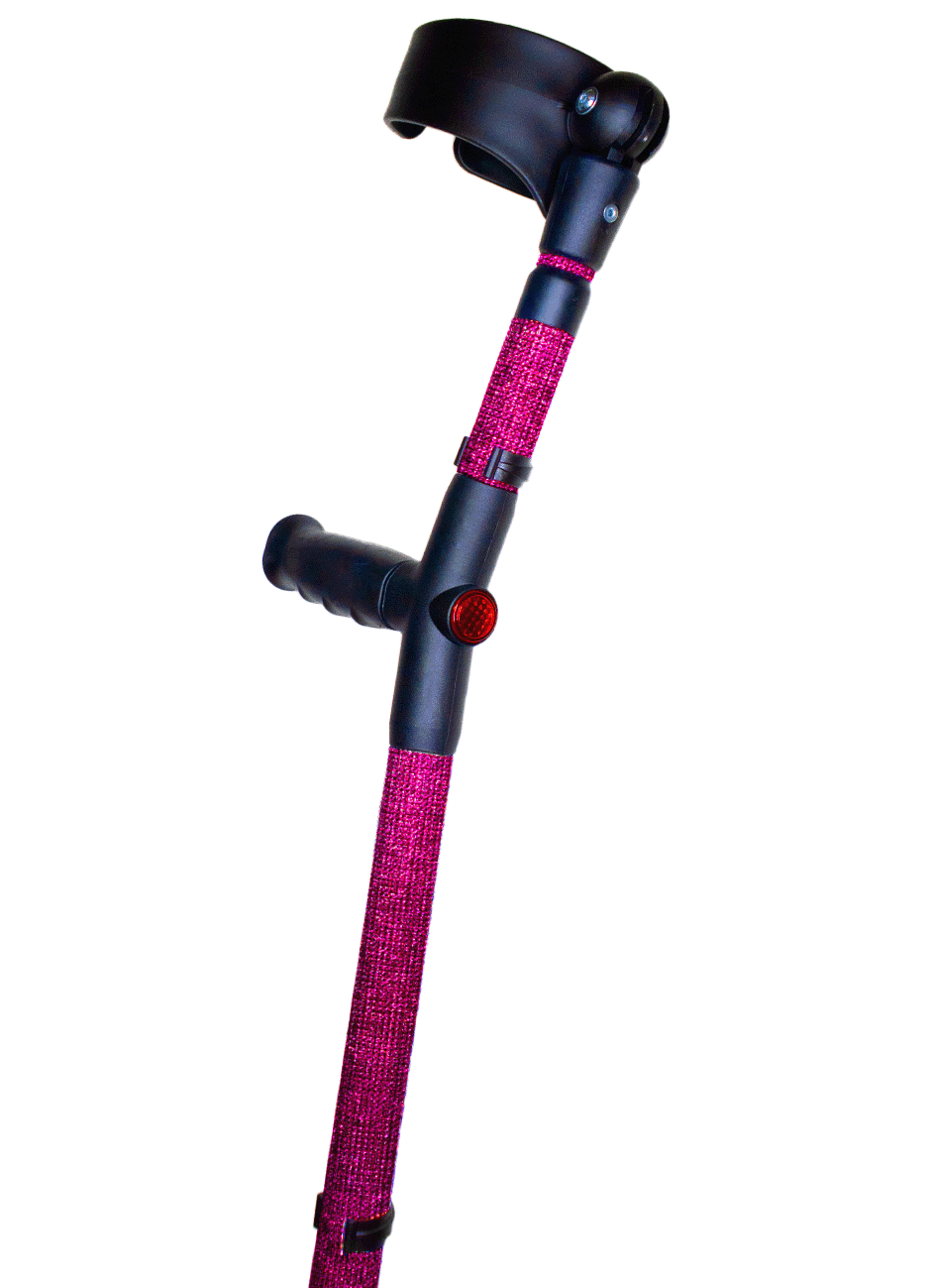 Crutch with a black handle and cuff decorated with dark pink coloured glass rhinestones.  The crutch also has a red reflective circle at the back and the front of the handle.