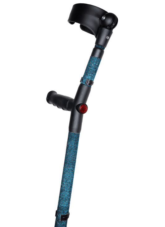 Crutch with a black handle and cuff decorated with teal blue coloured glass rhinestones.  The crutch also has a red reflective circle at the back and the front of the handle.