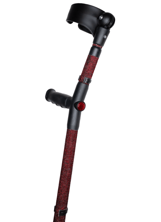 Crutch with a black handle and cuff decorated with dark red coloured glass rhinestones.  The crutch also has a red reflective circle at the back and the front of the handle.